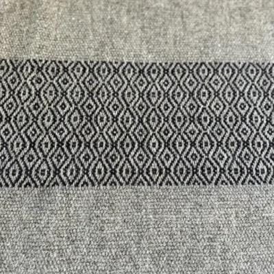 Tapis en Laine Tarasconnaise – Pièce Unique d'Artisanat d'Art** Succombez au charme authentique de ce tapis unique, entièrement tissé à la main à Toulouse sur un métier à bras traditionnel par l'artisane Line PARERA, fondatrice de l’Échoppe de Linette. Façonné en **laine cardée tarasconnaise** (filière française valorisée), il marie l'élégance brute d'un gris naturel à de superbes bandes graphiques bleu profond, teintées de manière écoresponsable à l'atelier. Un travail d'orfèvre aux motifs géométriques rythmés, sublimé par des finitions soignées en double nœuds. * **Dimensions :** 102 cm $\times$ 71 cm * **Composition :** 100% laine française (tarasconnaise) * **Temps de réalisation :** 6 heures de tissage méticuleux Une pièce de caractère durable, chaleureuse et écoresponsable pour sublimer votre intérieur.